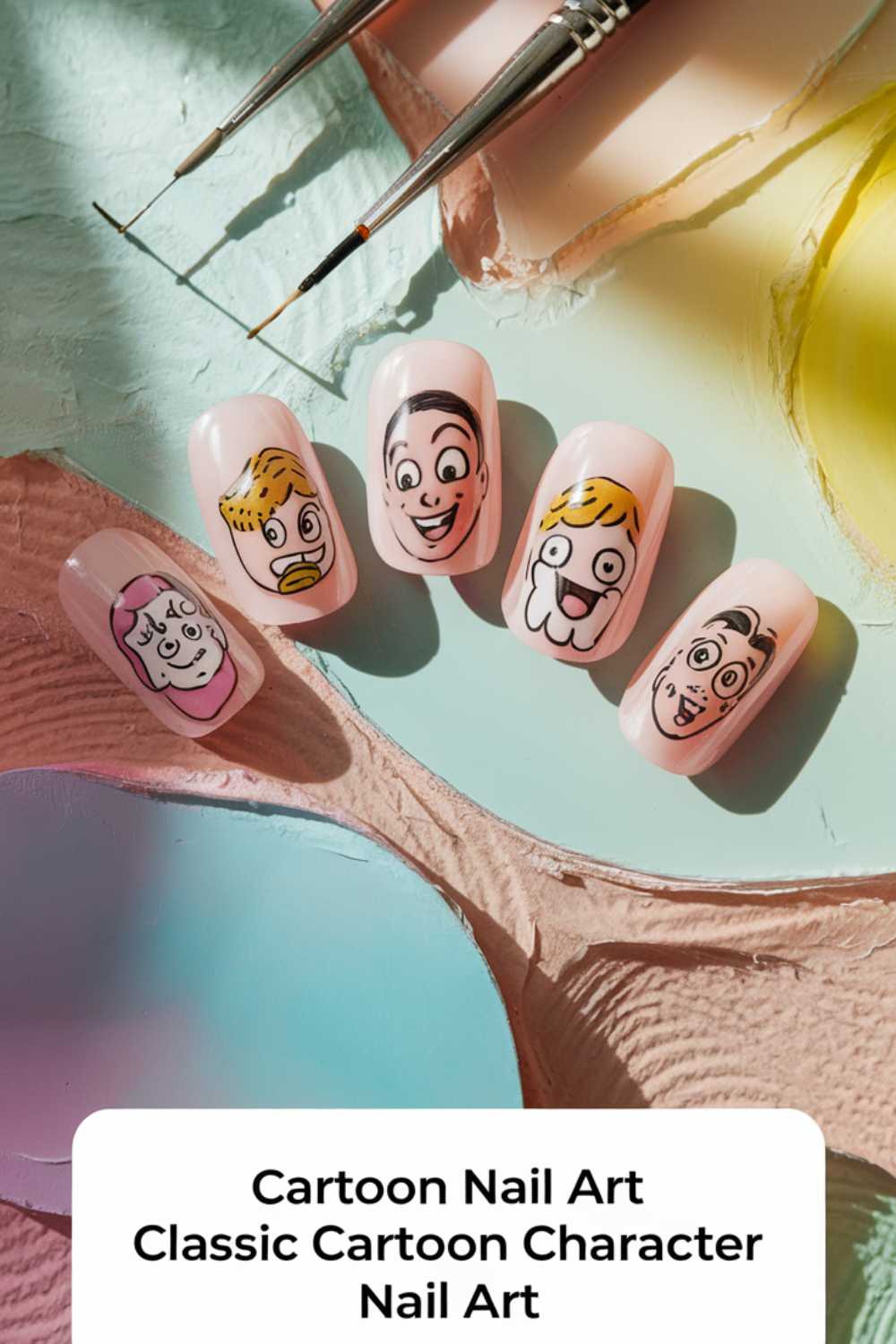 Five nail tips with classic cartoon character faces painted on them rest on a textured pastel background. Two fine-tipped paintbrushes hover above, capturing the essence of Cartoon Nail Art Designs. Text at the bottom reads, Cartoon Nail Art Classic Cartoon Character Nail Art.